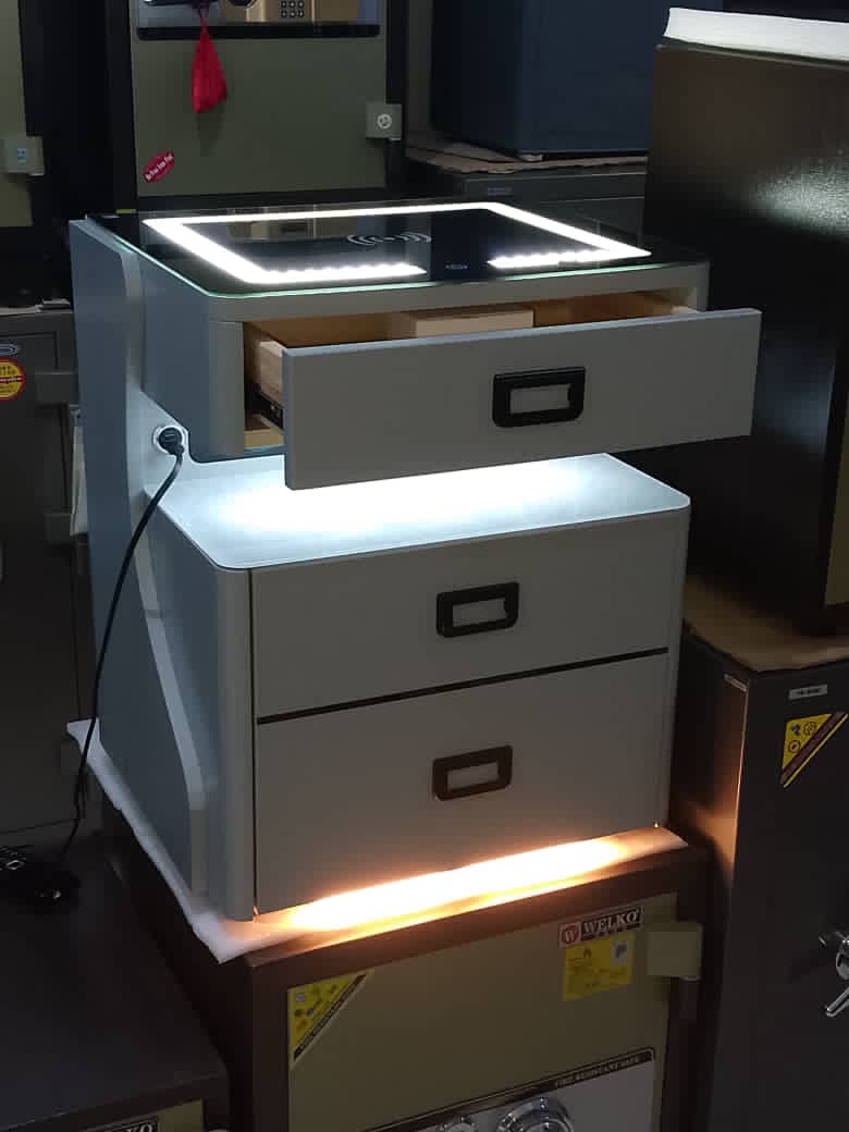 Smart bedside table with built-in safe. Wireless charging ports.